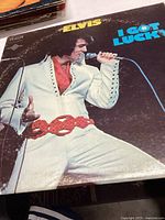 Front album cover showing Elvis in white jumpsuit and title