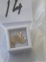 Pendant in box inside plastic bag marked 14