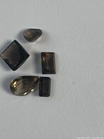 Five smokey quartz stones on white background