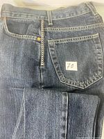 Back view showing pocket label, waistband, sticker 70