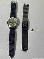 Front view of both watches showing cases, dials and straps