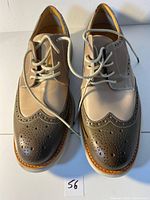 Top view of the two-tone leather wingtip shoes with laces