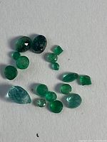 All 15 emerald gemstones displayed on white background