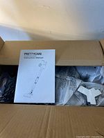 Instruction manual atop boxed vacuum components