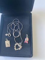 Necklace and three pendants in box