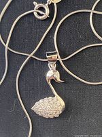Close-up of swan pendant and chain