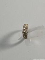 Full view of silver-tone ring standing on edge