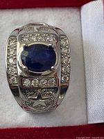 Top view of ring showing sapphire, clear stones, star and crescent motif
