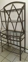 Full view of metal and glass baker's rack