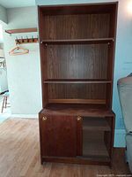 Full view of teak bookshelf showing open shelves and lower sliding-door cabinet