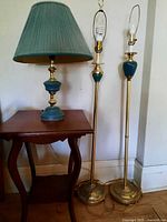 All three brass lamps standing together showing condition and presence or absence of shades