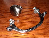 Representative satin finish round knob and curved handle with mounting screws