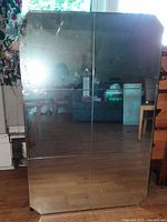 Front view of rectangular vintage mirror with beveled edges and etched quadrant lines