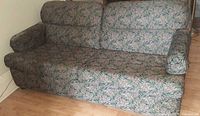 Front view of entire blue floral loveseat