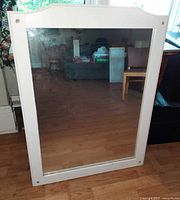 Front view of rectangular mirror with white frame