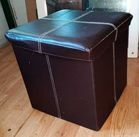 Cube footstool showing vinyl surface, stitching and removable lid
