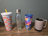 Front view of all four Starbucks drinkware items