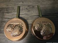 Both copper plated strawberry pans front view