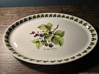 Top view of oval platter showing blackberry motif and leaf border