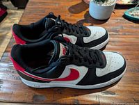 Side view of both sneakers on table