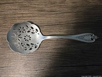 Top view showing pierced scalloped bowl and handle design