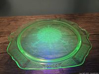 Top view of glowing green uranium glass cake plate