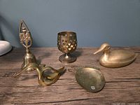 All five brass items grouped on tabletop