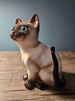 front view of ceramic Siamese cat figurine