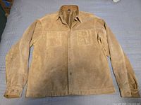 Front view of tan suede leather shirt jacket showing pockets, buttons, collar, cuffs