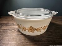 Side view showing gold Butterfly Gold pattern on casserole