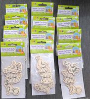 All 12 sealed packs of wood cut-outs displayed