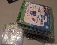 Stack of sealed LeapFrog LeapStart books showing First Day of School titles