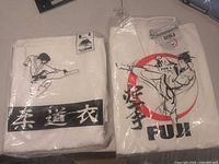Both sealed Fuji heavyweight karate gi packages displayed