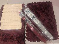 Four packaged placemat sets and several packaged pull bows grouped together