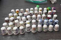 Group shot of all 41 decorative thimbles arranged in rows