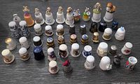 Front view of entire thimble collection arranged in rows