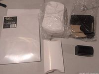 Stack of white flat boxes, bundles of white pillow boxes, bundle of flat black boxes