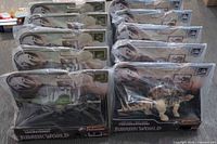 Group shot of ten sealed dinosaur figures stacked