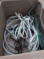 Box containing multiple coiled extension cords