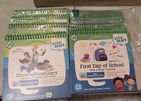 Stack of eight LeapStart books showing two cover designs, still in plastic