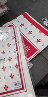 Sealed packages showing apron and towel pattern and printed Bon Appetit border