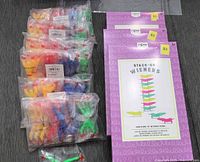 Overall lot showing three boxed NPW Stack-On Wieners games and multiple bags of sticky wall climbers