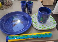 Group view of cups, bowls, plates, tray, placemat roll