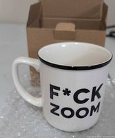 Mug outside its box showing text and handle