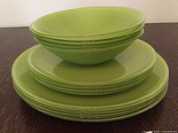 Stacked green plates and bowls showing color and quantity