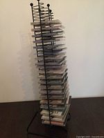 Full view of black metal CD rack filled with CDs