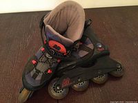 Left skate angled side view showing boot, frame, wheels