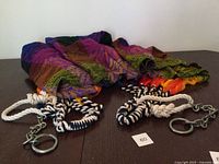 Entire folded hammock showing multicolor weave and both rope ends with rings