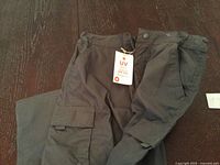 Full view of grey cargo pants with tags