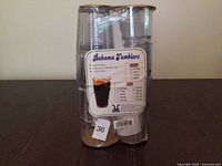 Front of packaged tumblers with label